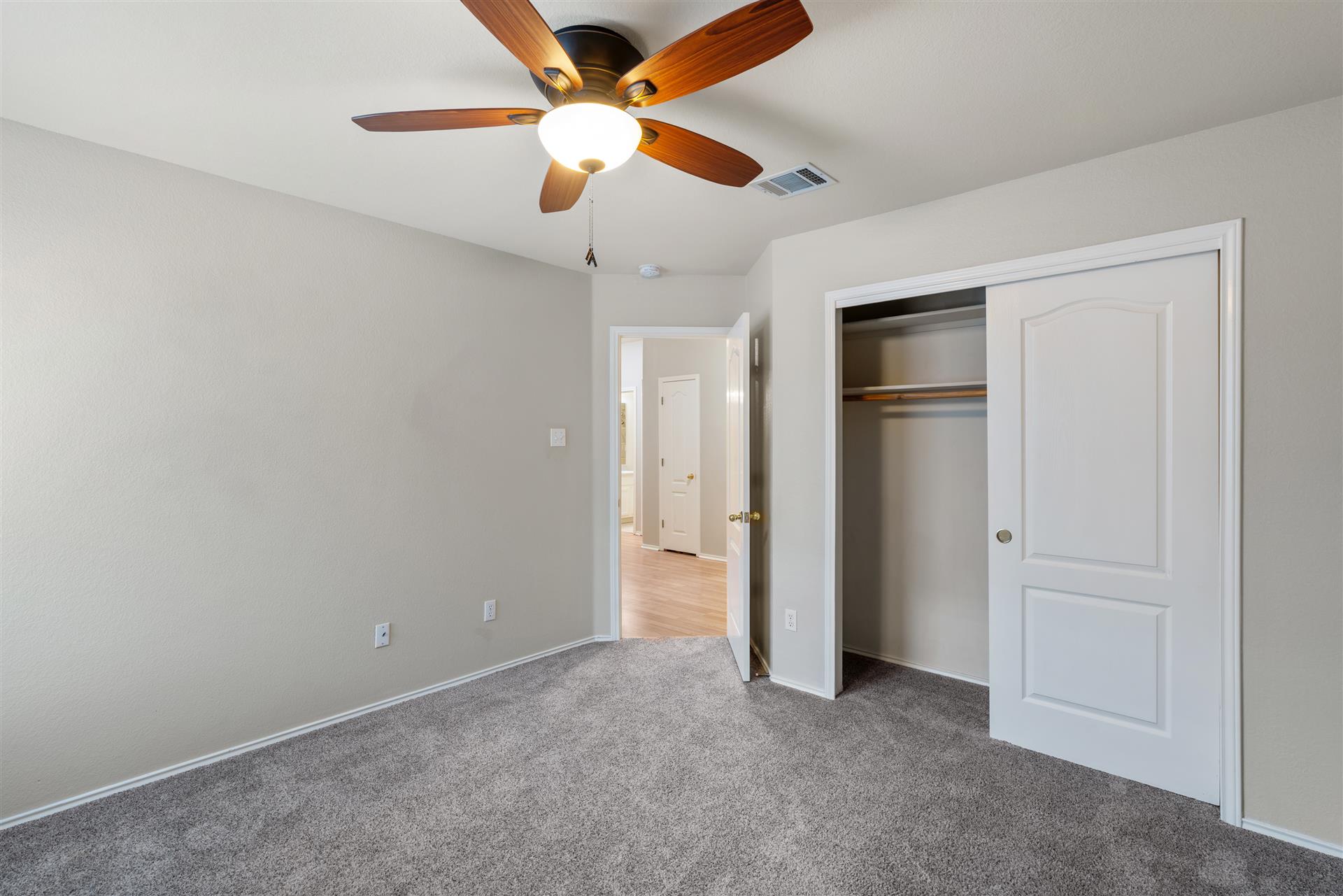 4725 Tello Path Austin, TX 78749 - Photo 24 of 34 A comfortable bedroom features plush carpeting, a functional closet, and an overhead ceiling fan.