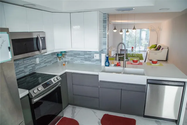 a kitchen with a sink appliances and cabinets