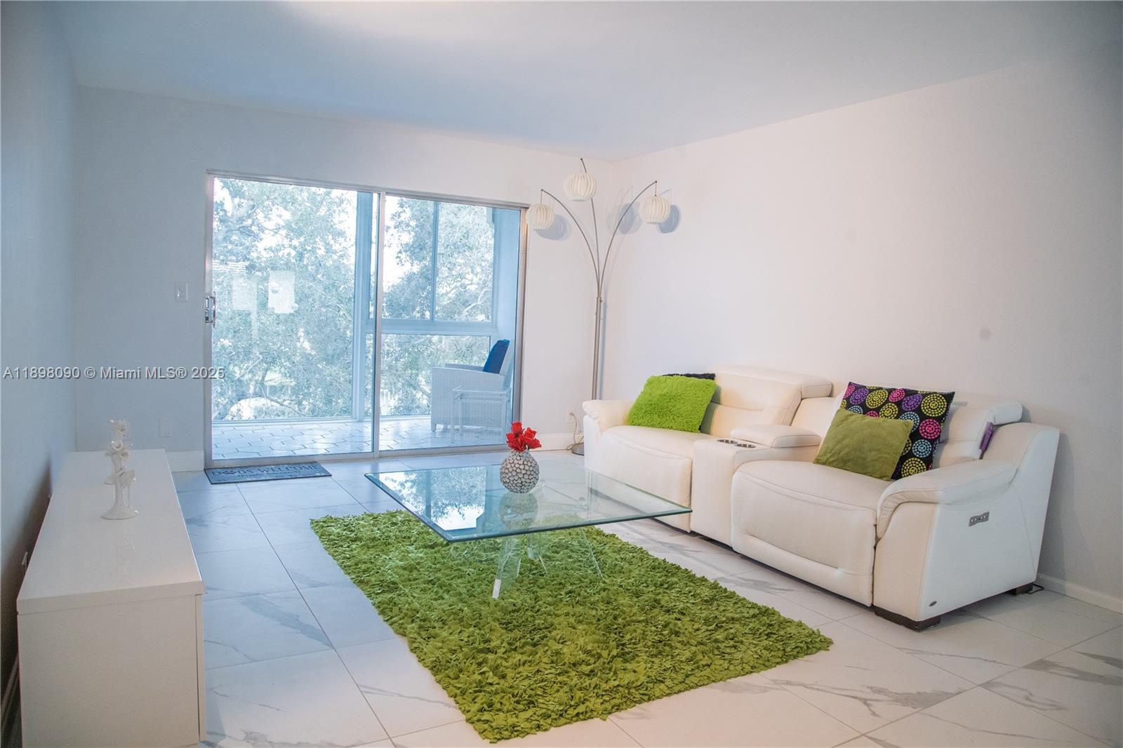 2304 Lucaya Lane, Unit J4 Coconut Creek, FL 33066 - Photo 20 of 50 a living room with furniture and a large window