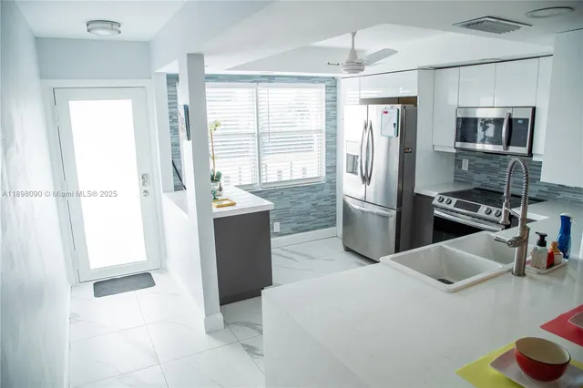a kitchen with stainless steel appliances a refrigerator and a sink