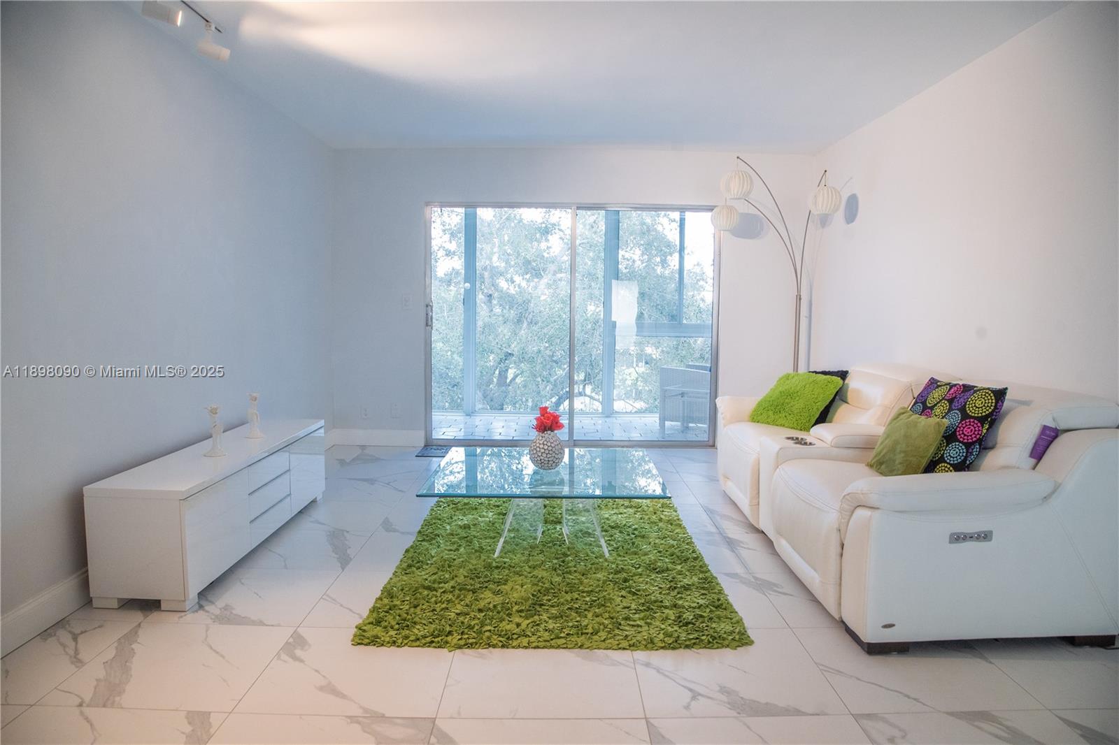 2304 Lucaya Lane, Unit J4 Coconut Creek, FL 33066 - Photo 21 of 50 a living room with a couch and a table