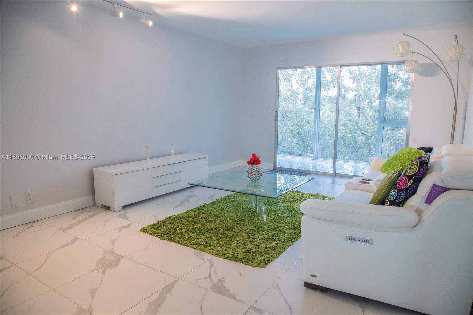 2304 Lucaya Lane, Unit J4 Coconut Creek, FL 33066 - Photo 22 of 50 a living room with couch and a table