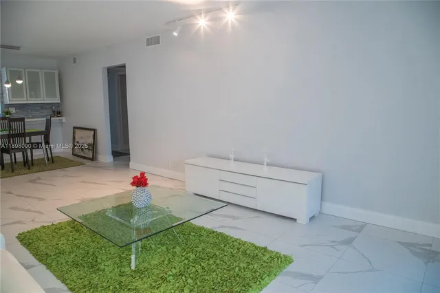 a view of a room with cabinets and table