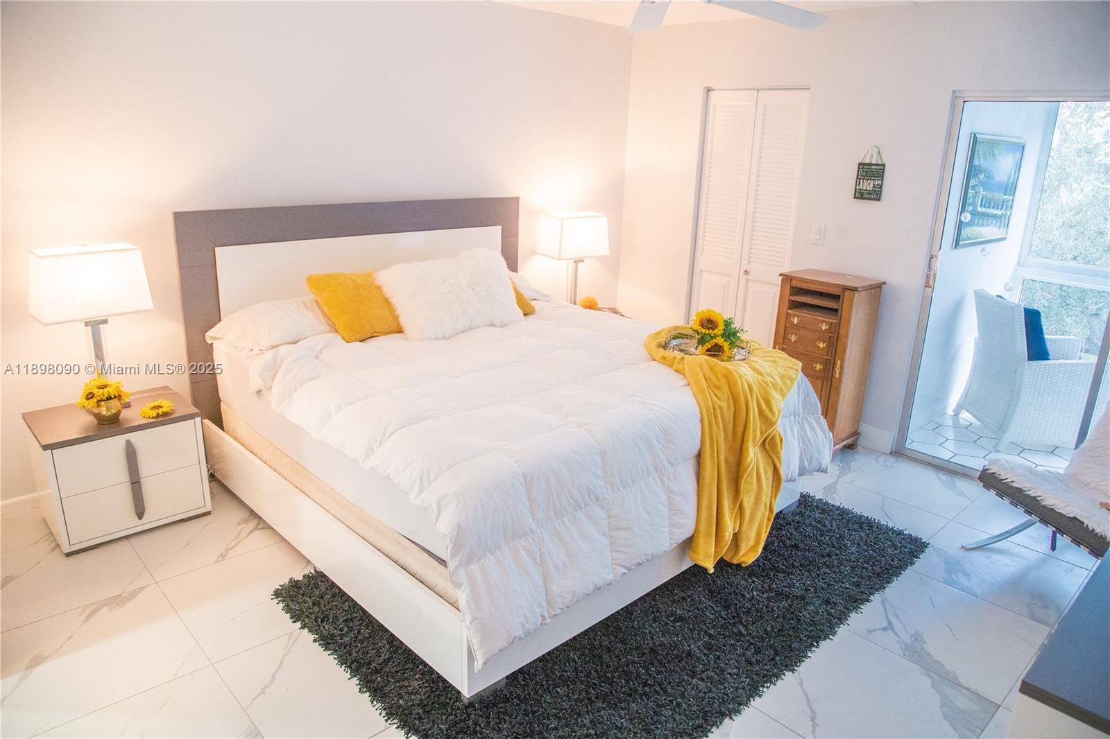 2304 Lucaya Lane, Unit J4 Coconut Creek, FL 33066 - Photo 33 of 50 a bedroom with a bed and wooden floor