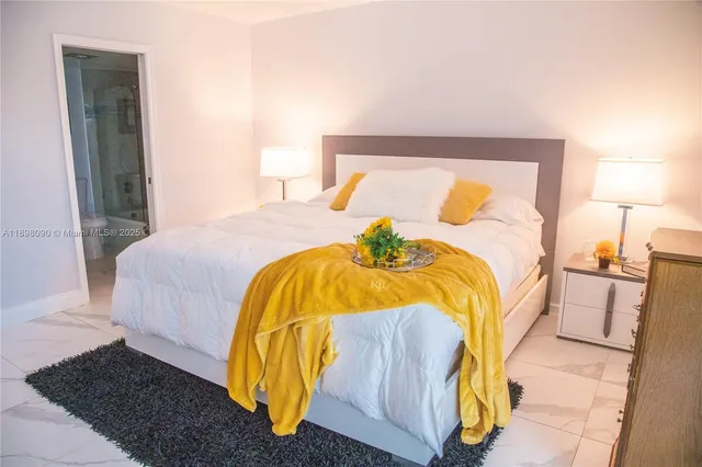 a bedroom with a bed and a lamp