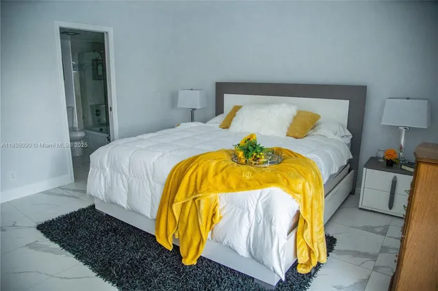 a bedroom with a bed and a lamp on desk