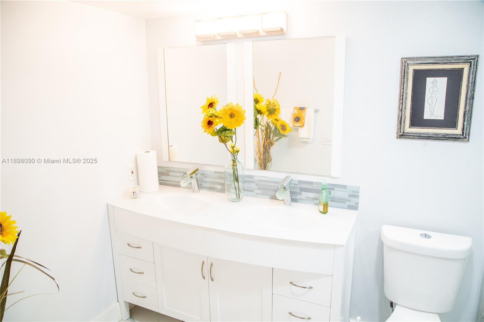 2304 Lucaya Lane, Unit J4 Coconut Creek, FL 33066 - Photo 39 of 50 a bathroom with a sink a toilet and a mirror