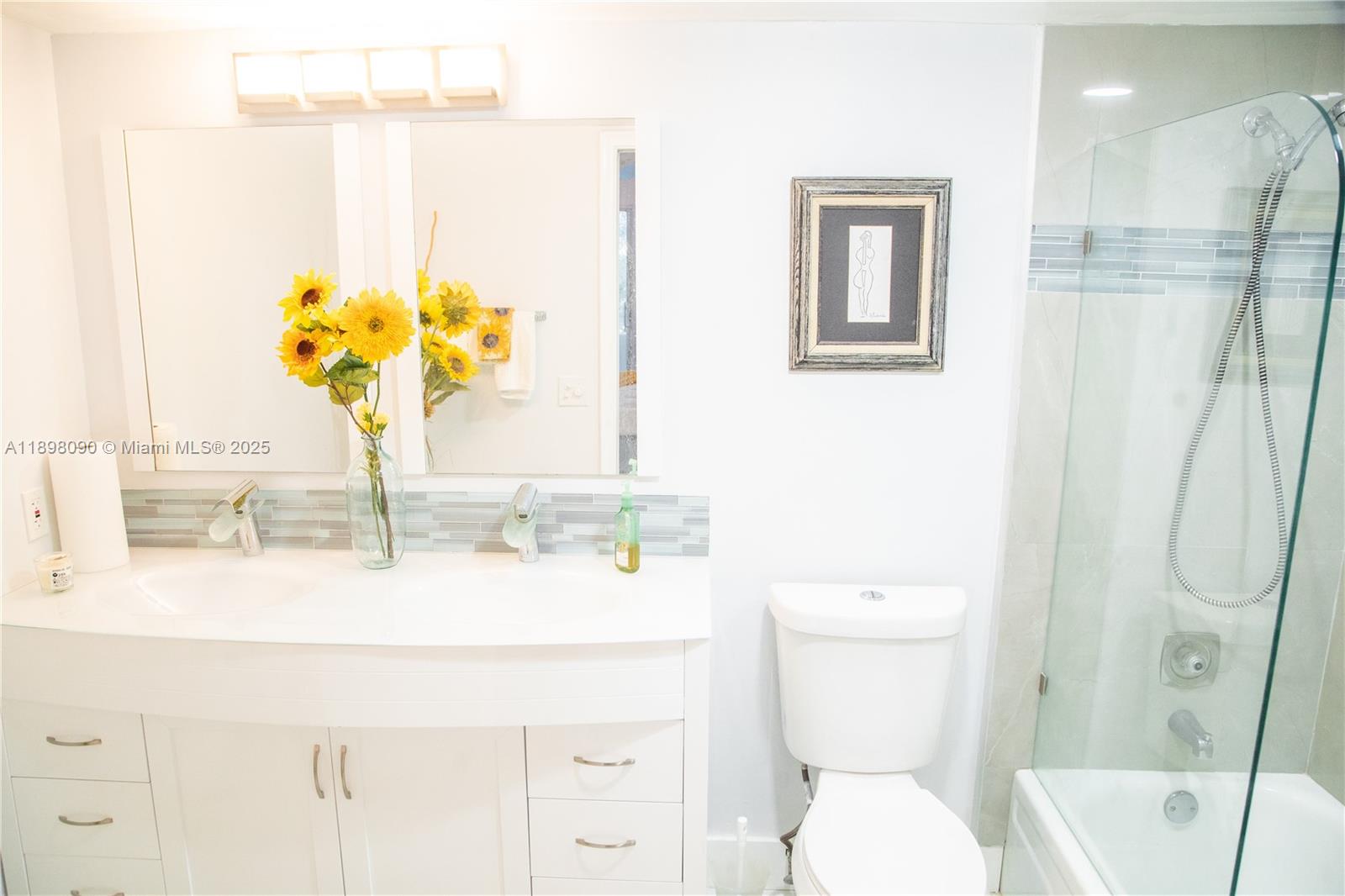 2304 Lucaya Lane, Unit J4 Coconut Creek, FL 33066 - Photo 40 of 50 a bathroom with a sink a toilet and a mirror