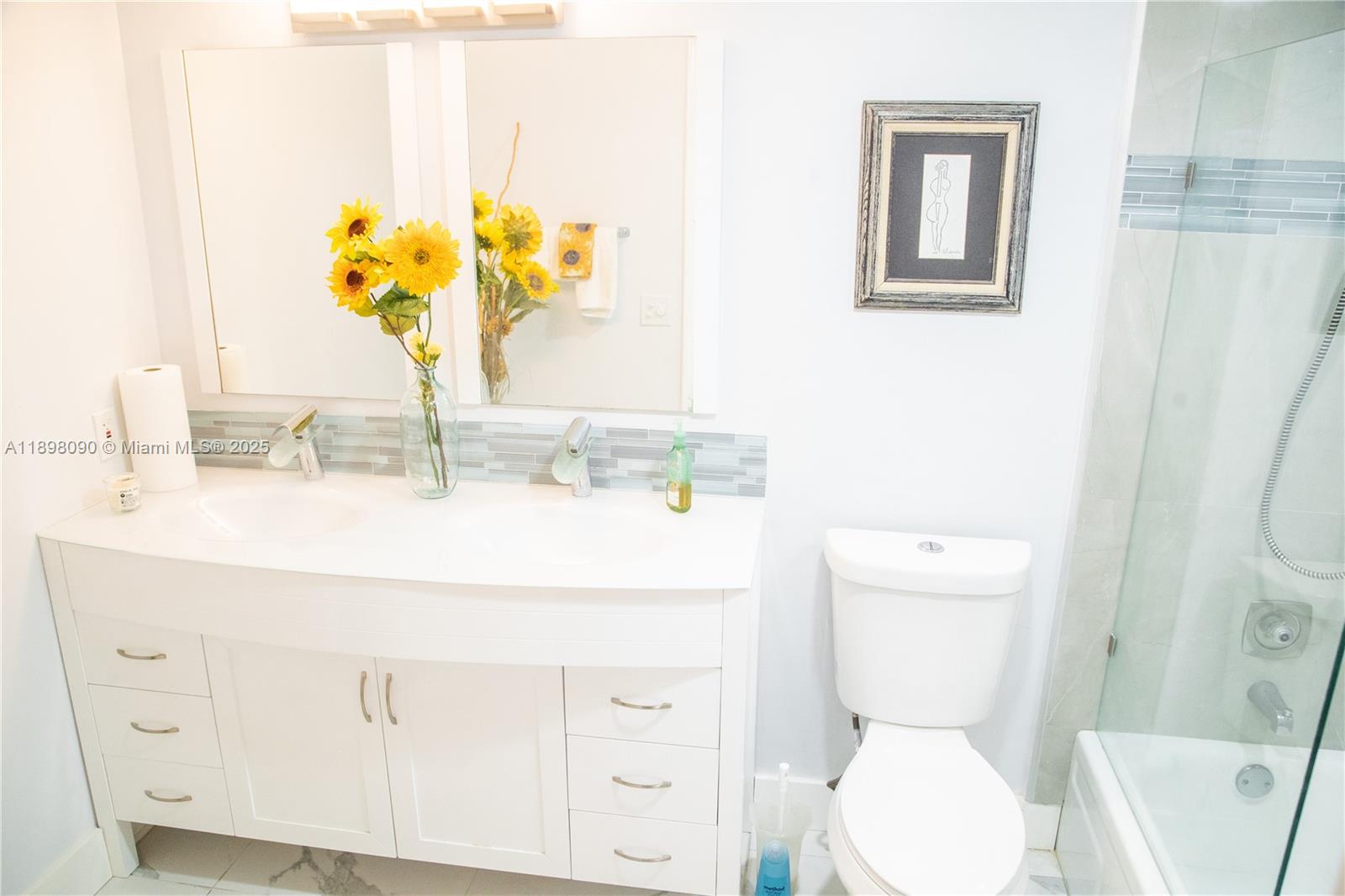 2304 Lucaya Lane, Unit J4 Coconut Creek, FL 33066 - Photo 41 of 50 a bathroom with a sink a toilet and a mirror