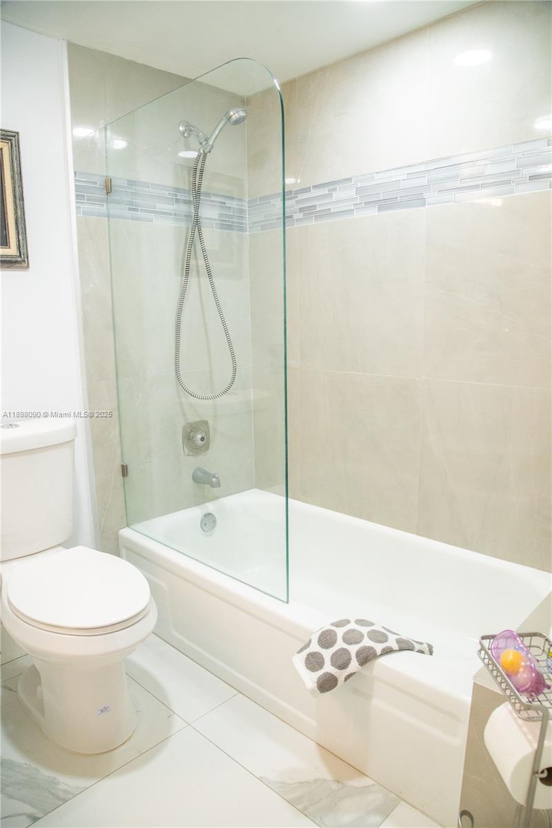 2304 Lucaya Lane, Unit J4 Coconut Creek, FL 33066 - Photo 43 of 50 a bathroom with a toilet and a shower