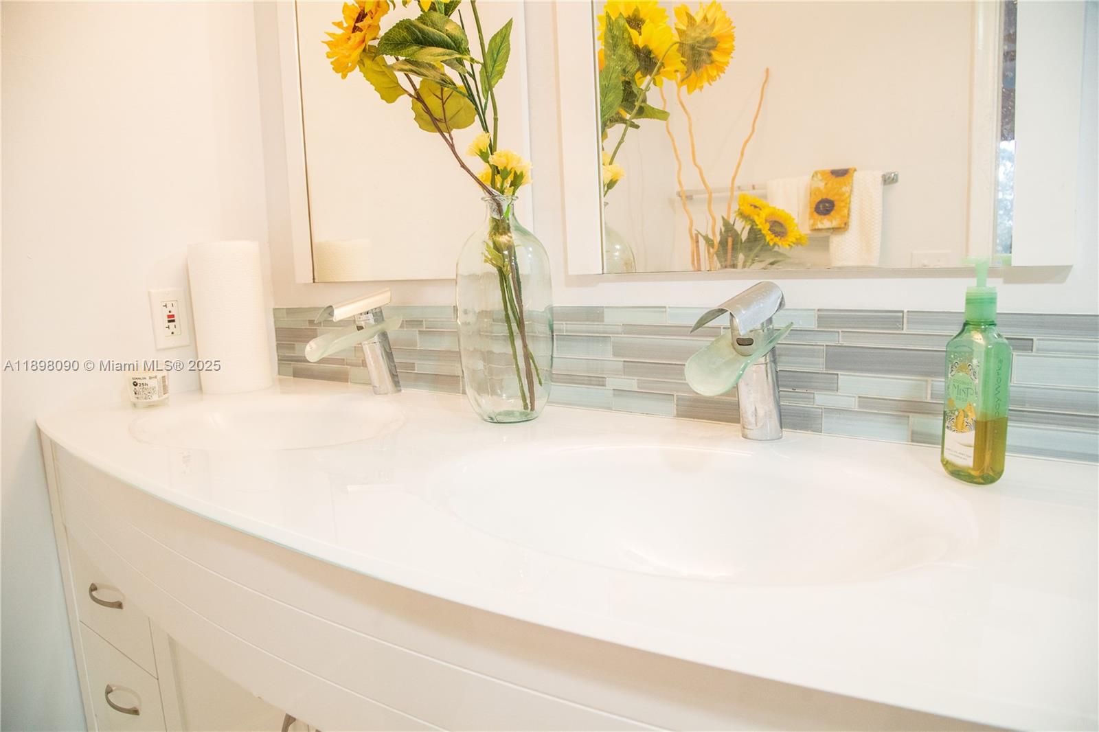 2304 Lucaya Lane, Unit J4 Coconut Creek, FL 33066 - Photo 44 of 50 a bathroom with a sink and a mirror