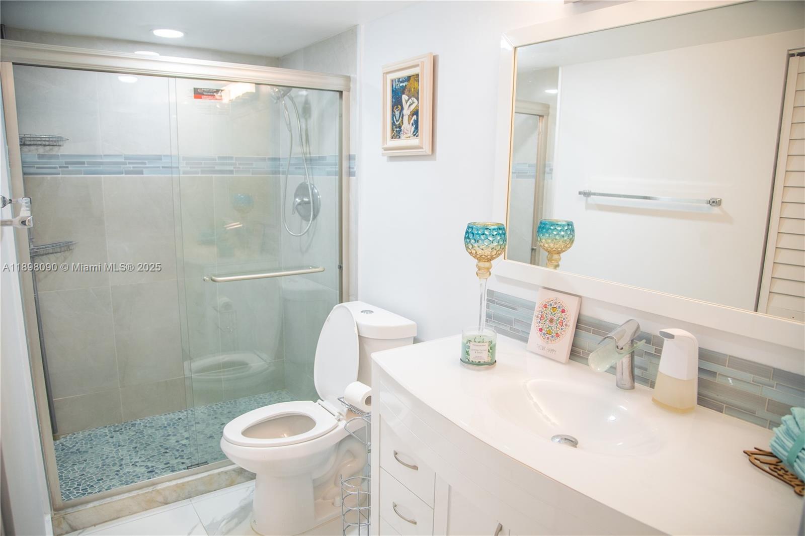 2304 Lucaya Lane, Unit J4 Coconut Creek, FL 33066 - Photo 46 of 50 a bathroom with a sink toilet and shower