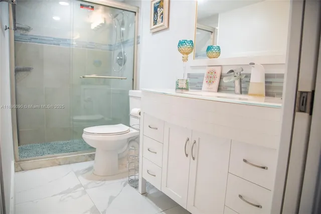 a white toilet sitting next to a bathroom sink