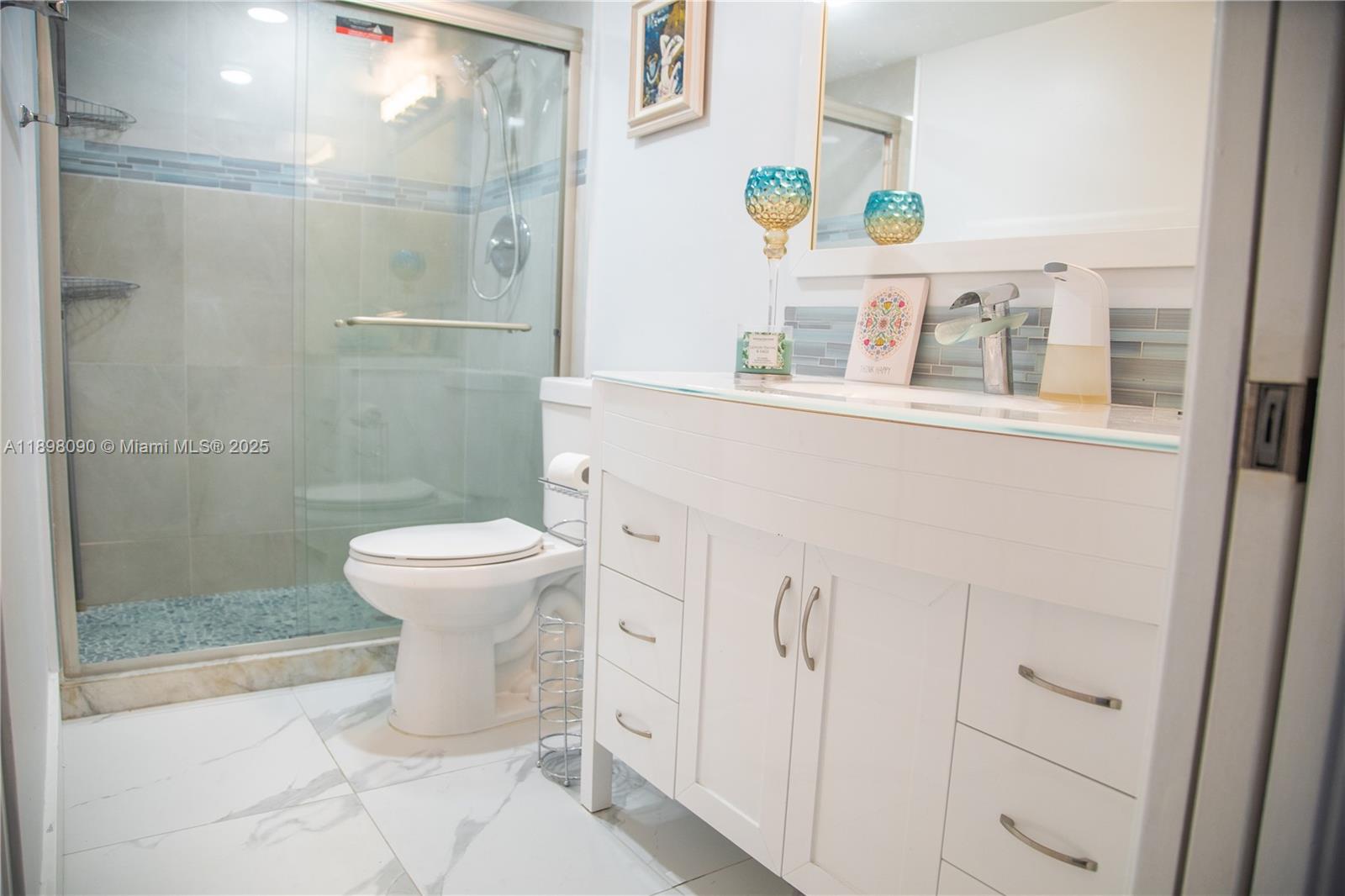 2304 Lucaya Lane, Unit J4 Coconut Creek, FL 33066 - Photo 50 of 50 a white toilet sitting next to a bathroom sink