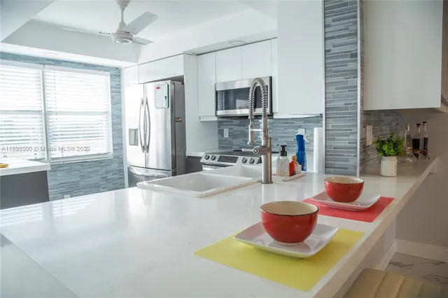 a kitchen with a sink and wooden floor