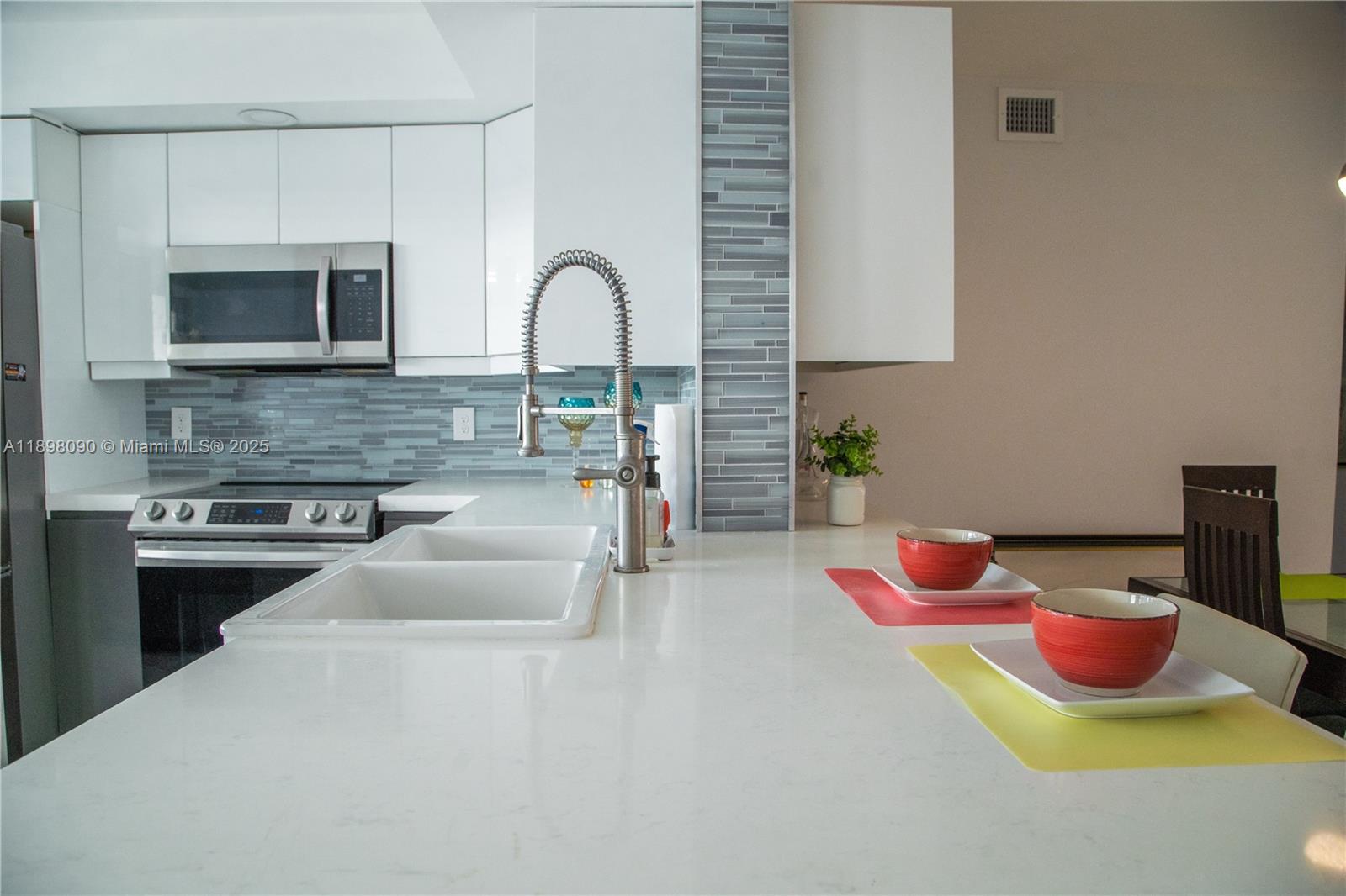 2304 Lucaya Lane, Unit J4 Coconut Creek, FL 33066 - Photo 8 of 50 a kitchen with a microwave and a stove