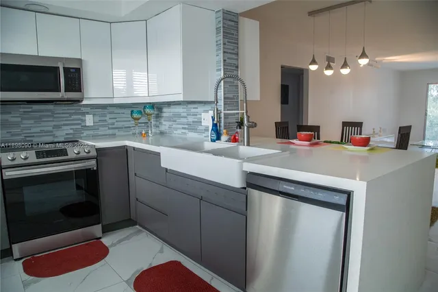 a kitchen with a sink cabinets and stainless steel appliances