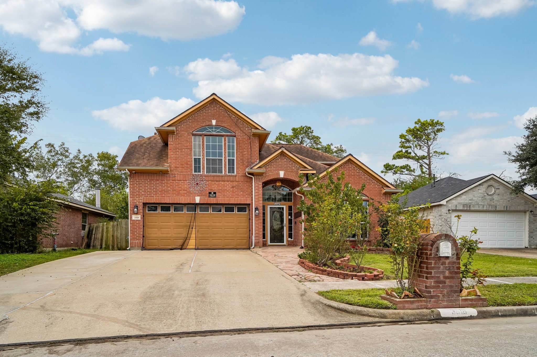 3818 Ridge Canyon Road Baytown, TX 77521 - Photo 2 of 32 a front view of a house with a yard and garage