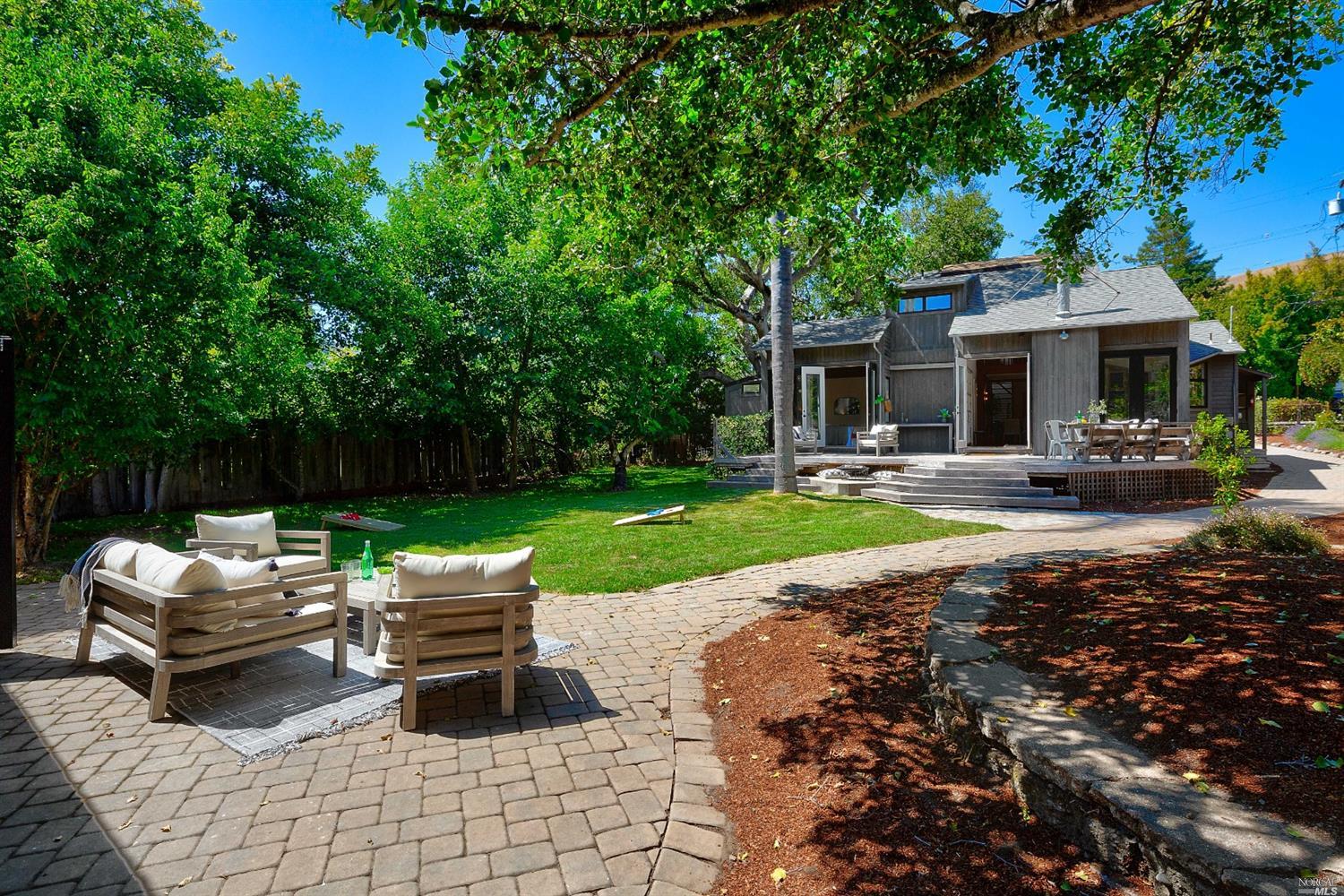 a view of a patio with couches and a table and chairs with garden view