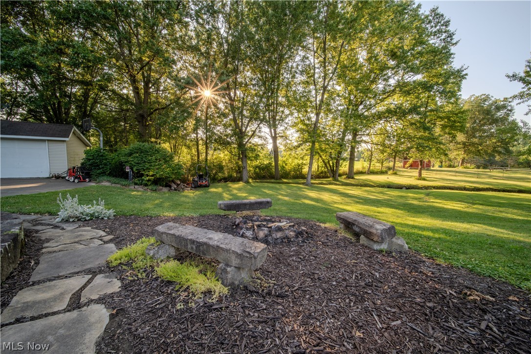 6549 Waterloo Road Atwater, OH 44201 - Photo 45 of 49 Expansive outdoor space featuring a stone fire pit area with two stone benches