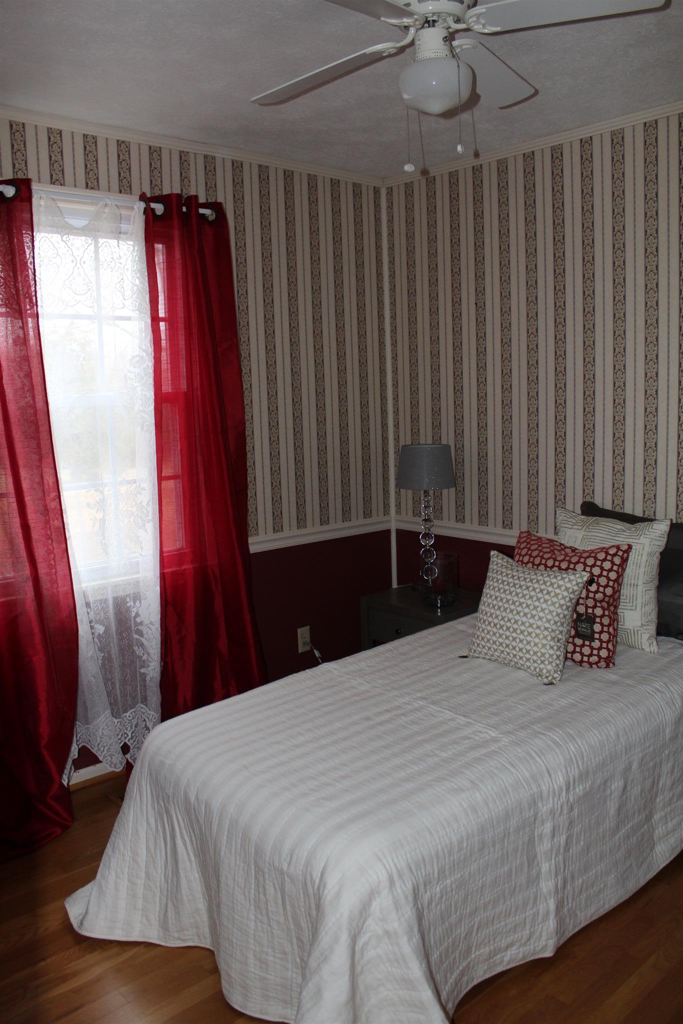 640 Pruett Road Dickson, TN 37055 - Photo 20 of 28 a bedroom with a bed and a mirror