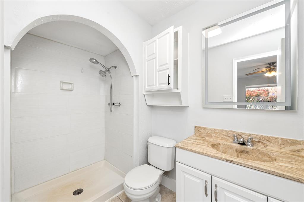 2119 Meadfoot Road Carrollton, TX 75007 - Photo 19 of 34 Bathroom with vanity, a shower stall, and ceiling fan