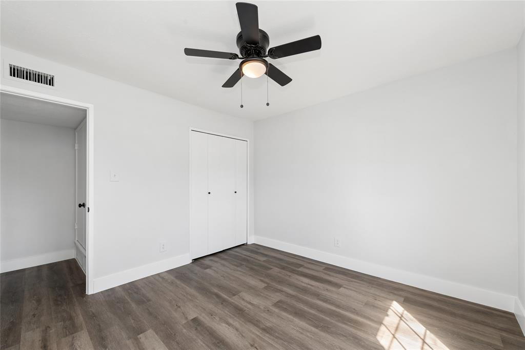 2119 Meadfoot Road Carrollton, TX 75007 - Photo 22 of 34 Unfurnished bedroom featuring dark wood finished floors, ceiling fan, and a closet