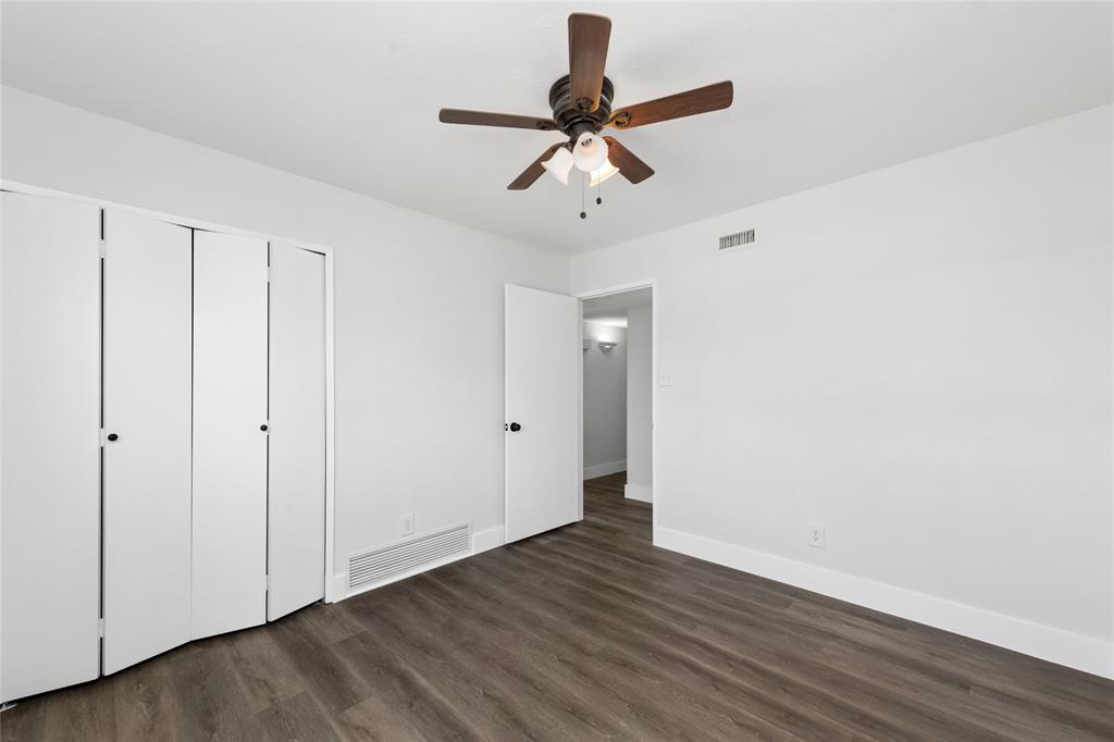 2119 Meadfoot Road Carrollton, TX 75007 - Photo 24 of 34 Unfurnished bedroom with a ceiling fan, dark wood-style flooring, and a closet