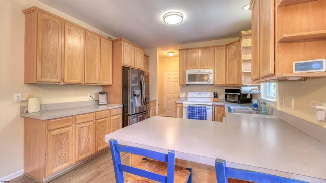 a room with pool tables and chandelier fan