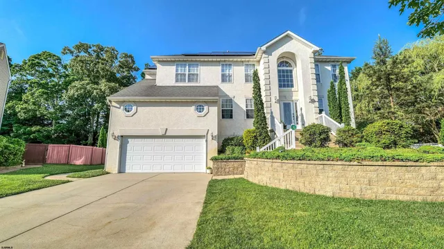 an aerial view of a house with a yard and outdoor seating