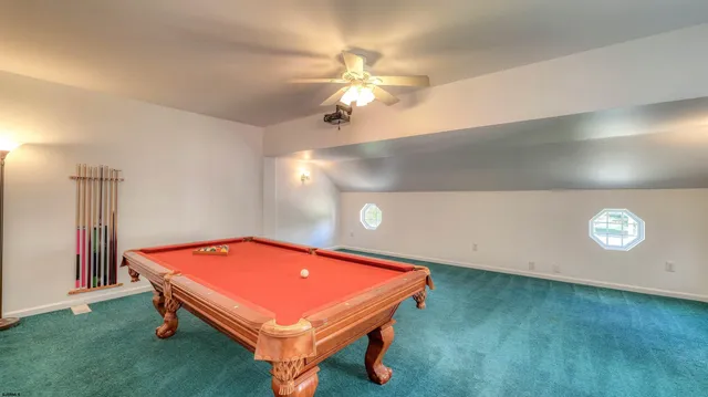 a spacious bathroom with a tub sink and mirror