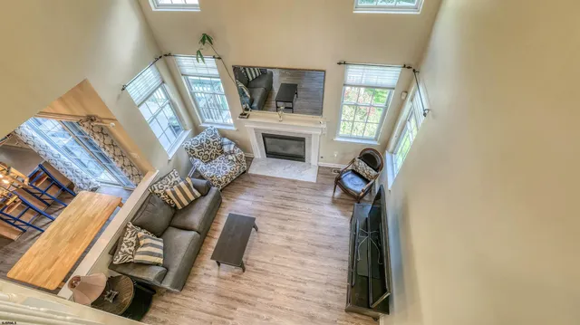 a view of an empty room and kitchen with fireplace