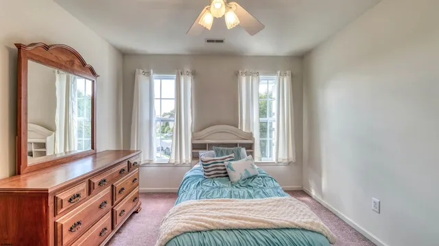 a kitchen with a refrigerator a stove top oven and cabinets