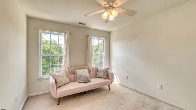 a view of a livingroom with a ceiling fan