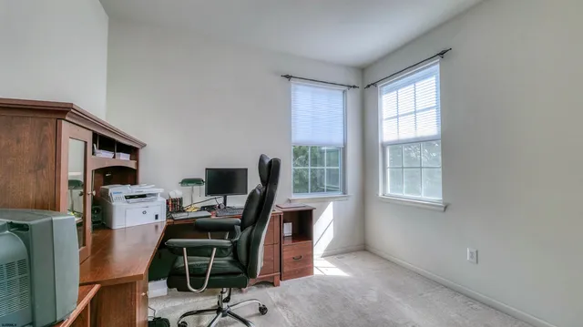 a kitchen with stainless steel appliances granite countertop a stove a refrigerator a sink a dining table and chairs with wooden floor