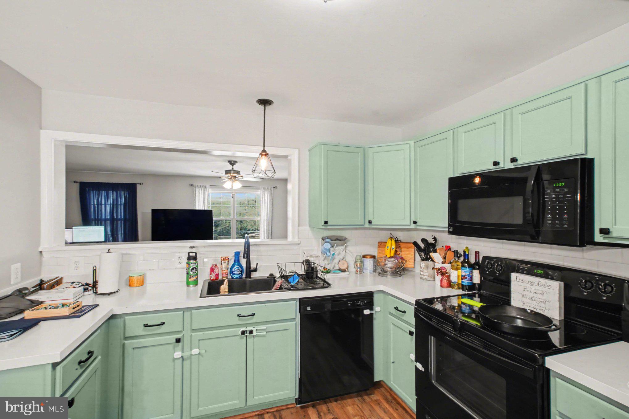 46 Morton Ridge Warrenton, VA 20186 - Photo 13 of 40 a kitchen with stainless steel appliances a stove sink microwave and cabinets