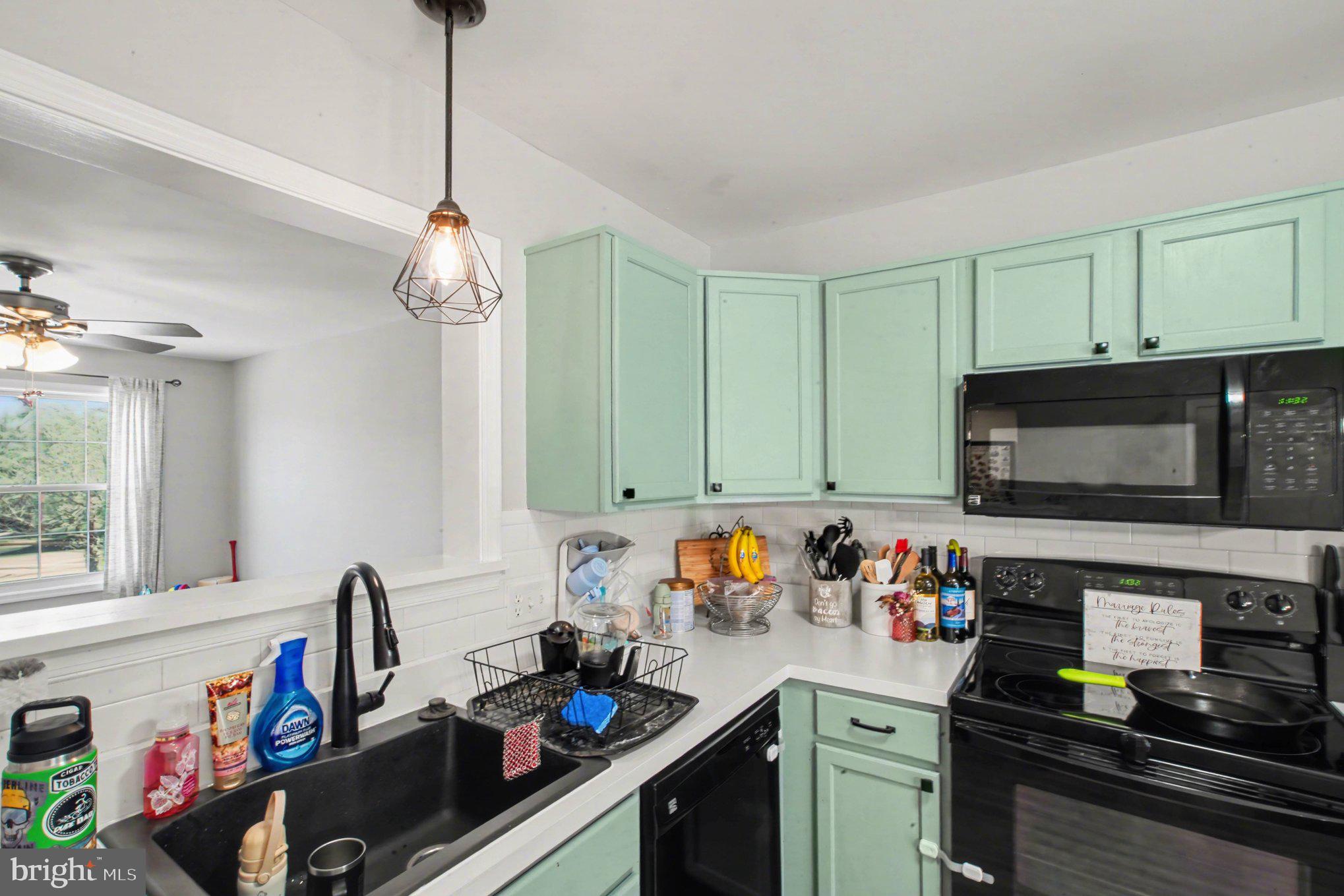 46 Morton Ridge Warrenton, VA 20186 - Photo 5 of 40 a kitchen with stainless steel appliances granite countertop a sink dishwasher a stove and a microwave oven with cabinets