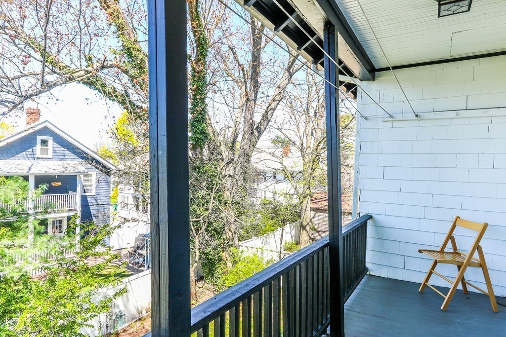 109 Adena Road, Unit 109 Newton, MA 02465 - Photo 21 of 23 a view of a chair and table in the balcony