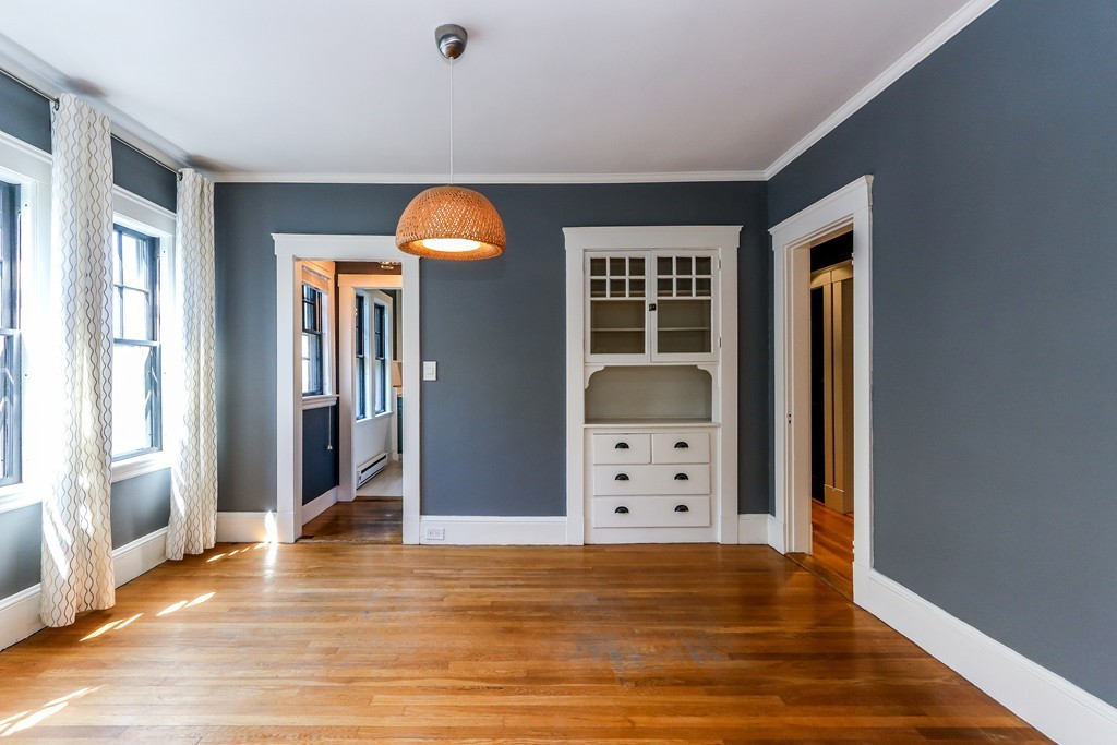 109 Adena Road, Unit 109 Newton, MA 02465 - Photo 8 of 23 wooden floor in an empty room with window and wooden floor