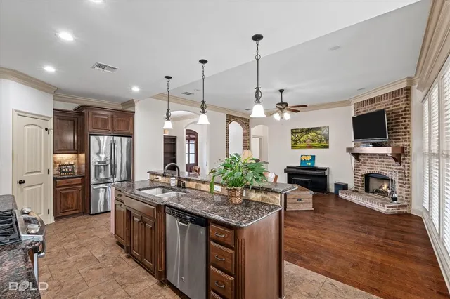 a kitchen with stainless steel appliances granite countertop a stove and refrigerator