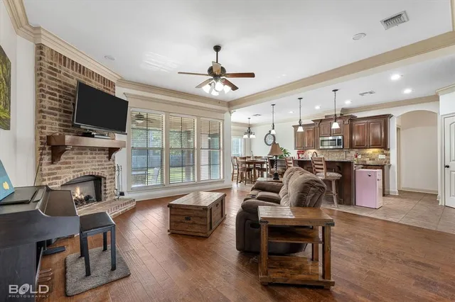 a living room with furniture fireplace and flat screen tv