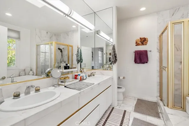 a bathroom with double vanity sink and a mirror