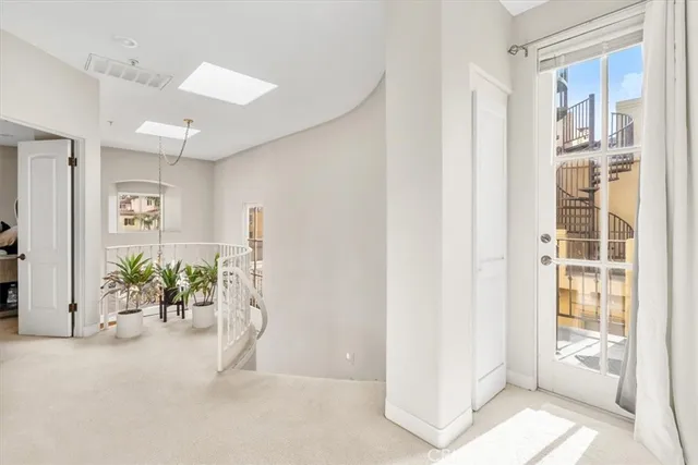 a view of a hallway with paintings on the wall