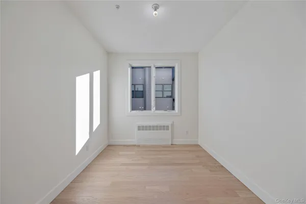 a view of a hallway with windows and entryway