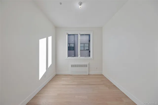 a view of a hallway with windows and entryway