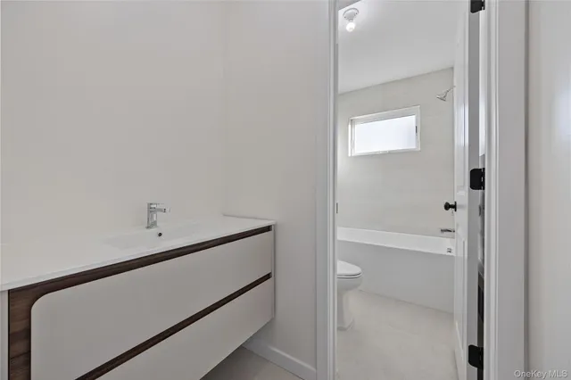 a bathroom with a toilet and a bathtub