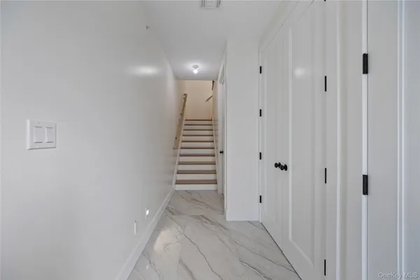 a view of a hallway with stairs