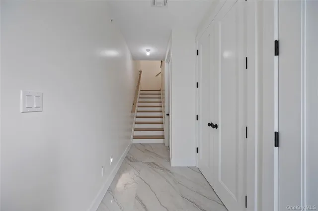 a view of a hallway with stairs