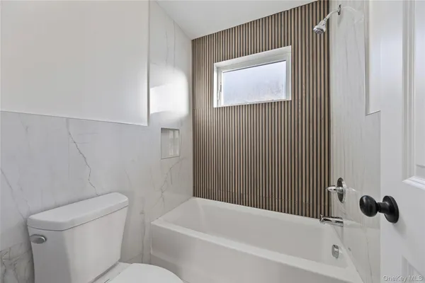 a white toilet sitting next to a bathroom sink