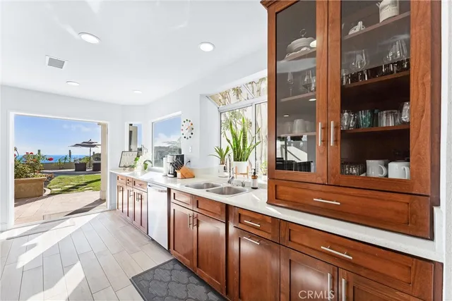 a open kitchen with stainless steel appliances granite countertop sink and wooden floor